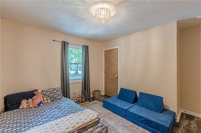 2642 Bridgehampton Rd SW, Marietta, GA 30064 - bedroom featuring wood finished floors, a textured ceiling, and baseboards