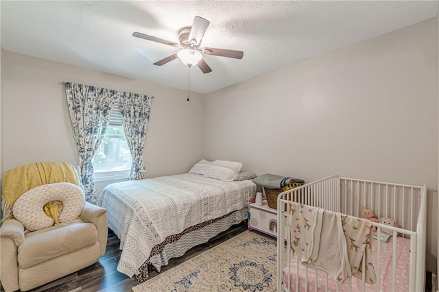 2642 Bridgehampton Rd SW, Marietta, GA 30064 - bedroom with wood finished floors, ceiling fan, and a textured ceiling