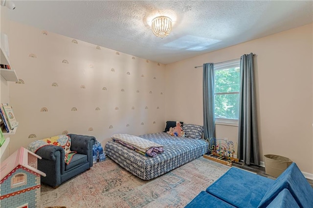 2642 Bridgehampton Rd SW, Marietta, GA 30064 - bedroom featuring a textured ceiling and a chandelier