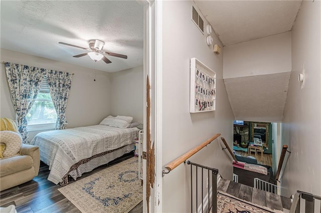 2642 Bridgehampton Rd SW, Marietta, GA 30064 - bedroom featuring a textured ceiling, wood finished floors, and a ceiling fan