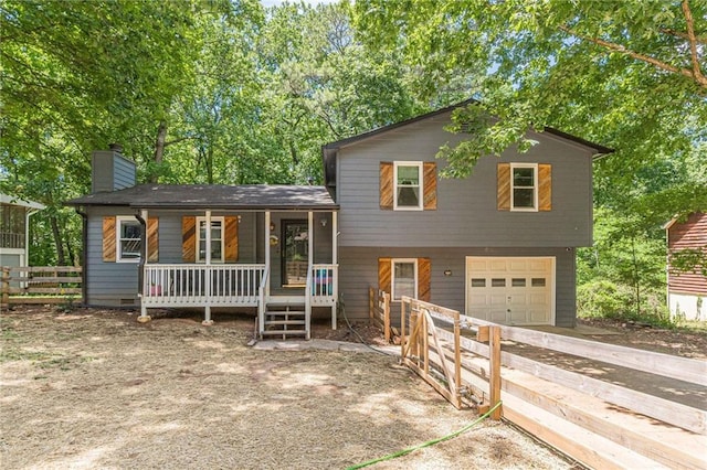 2642 Bridgehampton Rd SW, Marietta, GA 30064 - split level home featuring driveway, a porch, an attached garage, and a chimney