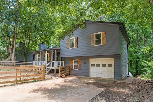 2642 Bridgehampton Rd SW, Marietta, GA 30064 - split level home featuring driveway, a garage, a porch, and a chimney