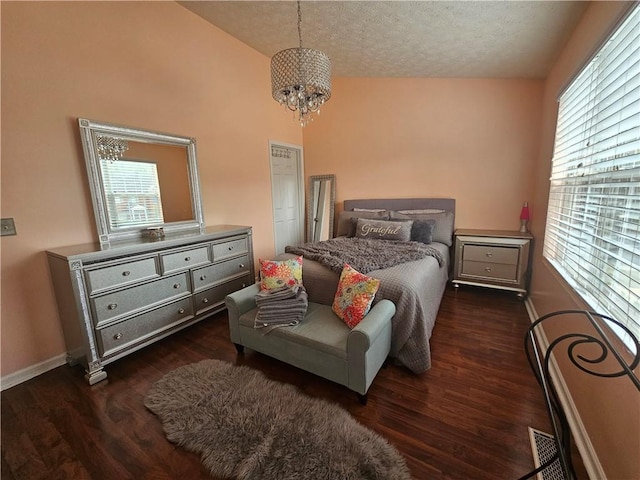 5536 Strathmoor Manor Cir, Lithonia, GA 30058 - bedroom featuring multiple windows, wood finished floors, a chandelier, baseboards, and a textured ceiling