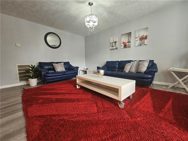 5536 Strathmoor Manor Cir, Lithonia, GA 30058 - living area featuring a textured ceiling, a chandelier, baseboards, and wood finished floors