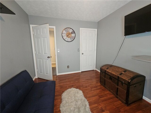 5536 Strathmoor Manor Cir, Lithonia, GA 30058 - living room with wood finished floors, baseboards, and a textured ceiling