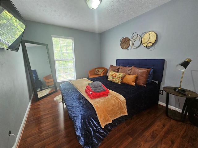 5536 Strathmoor Manor Cir, Lithonia, GA 30058 - bedroom featuring wood finished floors, a textured ceiling, and baseboards