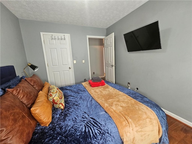 5536 Strathmoor Manor Cir, Lithonia, GA 30058 - bedroom with wood finished floors, baseboards, and a textured ceiling