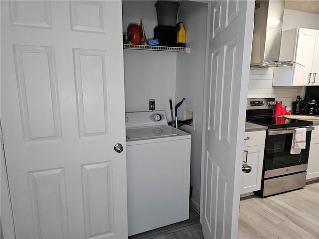 5536 Strathmoor Manor Cir, Lithonia, GA 30058 - laundry room featuring washer / clothes dryer and light wood-style flooring