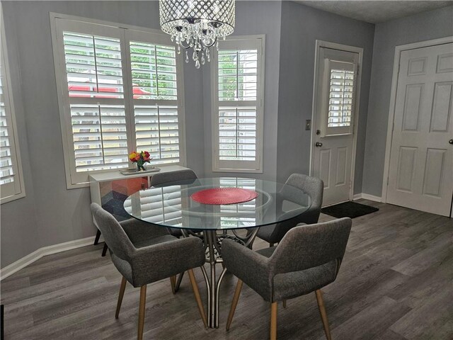 5536 Strathmoor Manor Cir, Lithonia, GA 30058 - dining room with a chandelier, wood finished floors, and baseboards