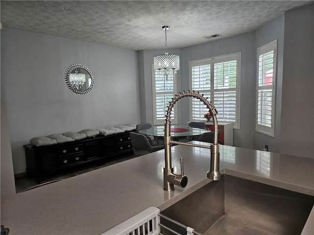 5536 Strathmoor Manor Cir, Lithonia, GA 30058 - kitchen view of a chandelier and a textured ceiling