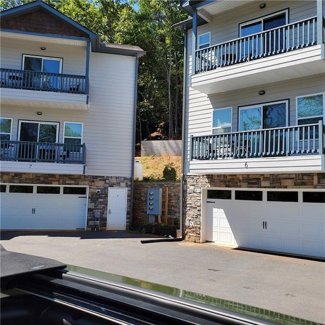 view of front facade with a balcony and a garage