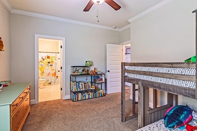 carpeted bedroom featuring ensuite bath and ornamental molding