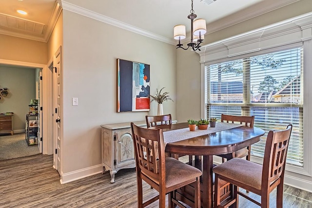 dining area with a chandelier, baseboards, dark wood-style floors, and ornamental molding