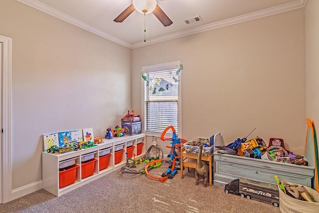 game room featuring baseboards, visible vents, ceiling fan, ornamental molding, and carpet flooring