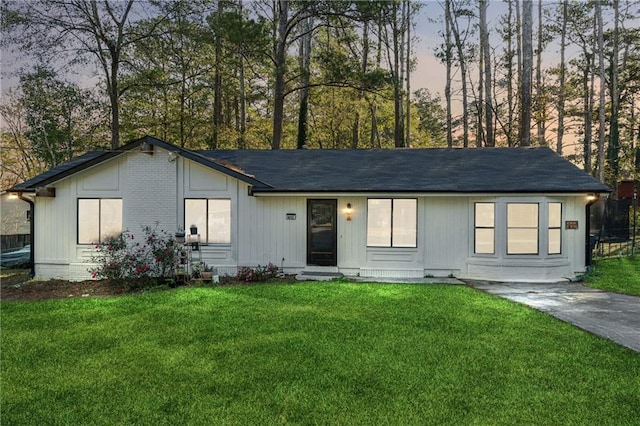 ranch-style house featuring a yard