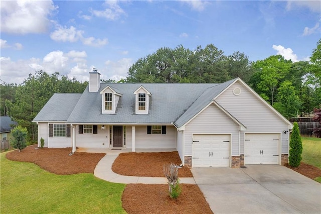 cape cod house featuring a porch, an attached garage, concrete driveway, a front yard, and a chimney