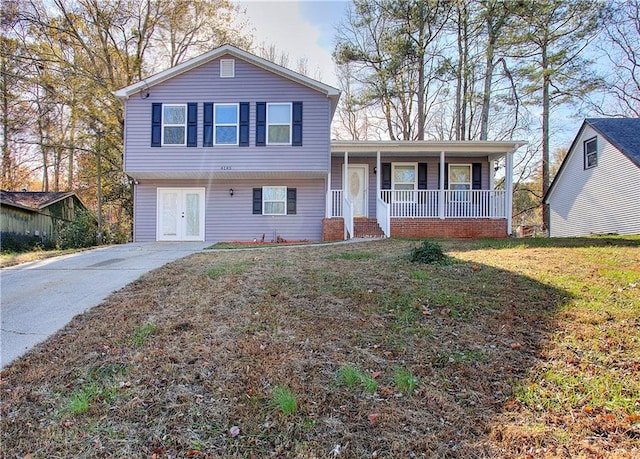 tri-level home featuring a front yard and french doors