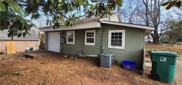 rear view of property with central air condition unit