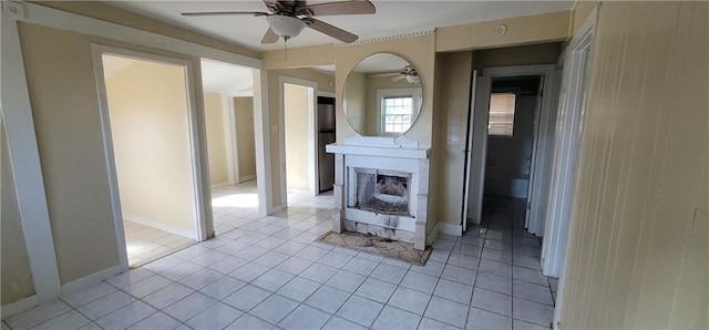 hallway with light tile patterned floors and baseboards