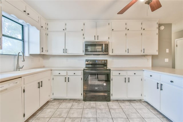 kitchen with sink, electric range, dishwasher, white cabinetry, and light tile patterned flooring