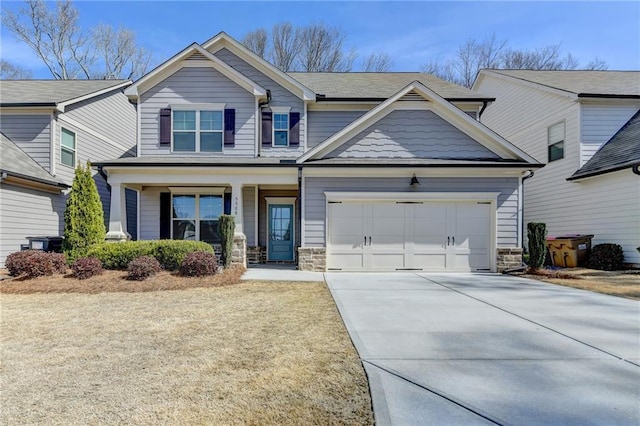 craftsman-style home with stone siding, an attached garage, covered porch, and driveway