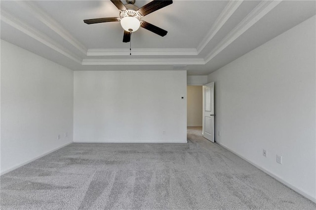 unfurnished room with carpet flooring, crown molding, a raised ceiling, and ceiling fan