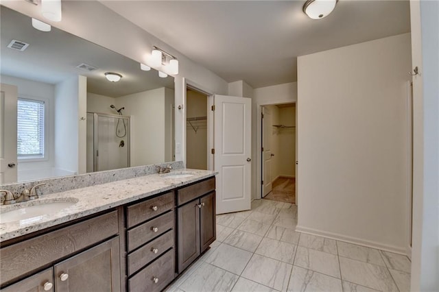 bathroom featuring a sink, visible vents, and marble finish floor