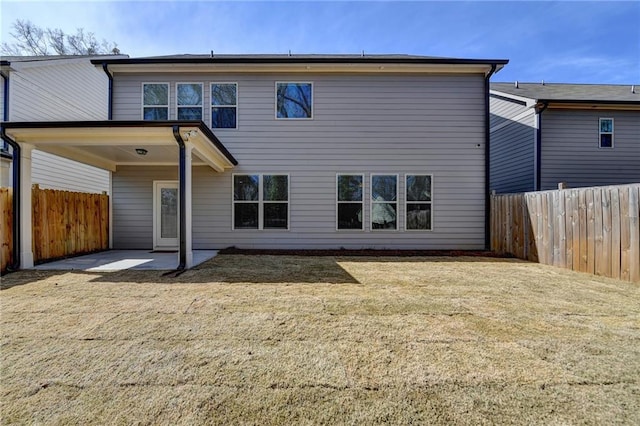 back of house with a yard, a patio, and a fenced backyard