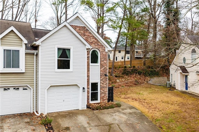 view of front of home with cooling unit and a garage