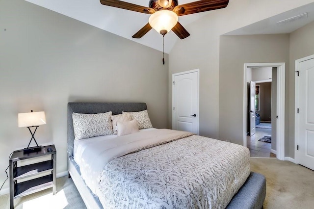 bedroom with visible vents, baseboards, high vaulted ceiling, and light carpet