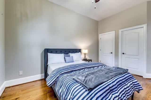 bedroom with baseboards and wood finished floors