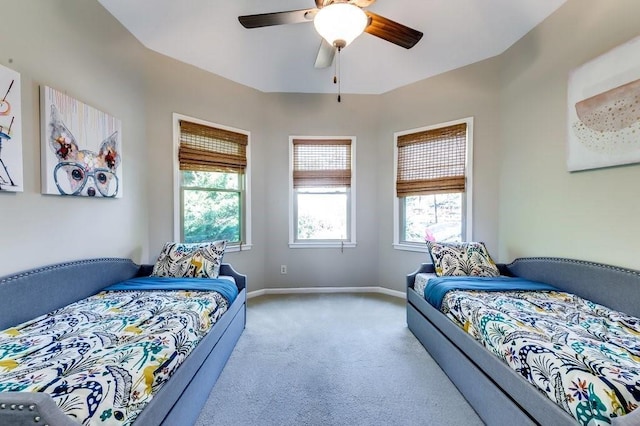 bedroom featuring baseboards, carpet flooring, and a ceiling fan