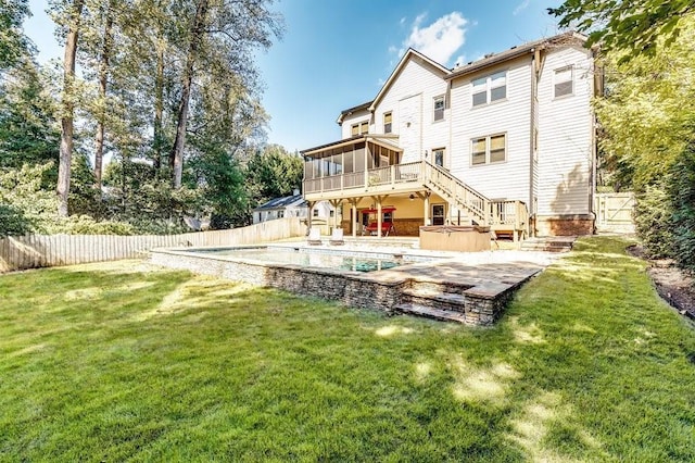 rear view of property with a hot tub, stairway, a fenced backyard, and a sunroom