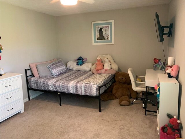 bedroom with a ceiling fan and light colored carpet