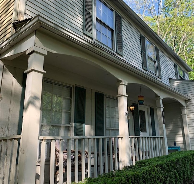 view of side of property with covered porch