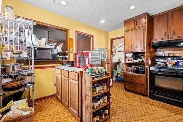 kitchen featuring a textured ceiling and black appliances