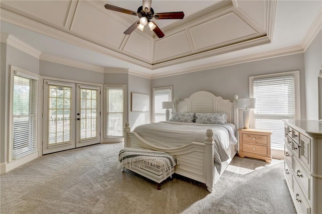 bedroom with ceiling fan, a tray ceiling, light colored carpet, and access to outside