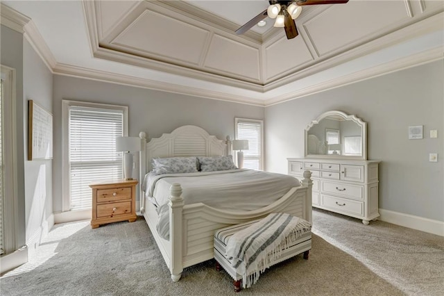 carpeted bedroom with ceiling fan, a tray ceiling, and crown molding