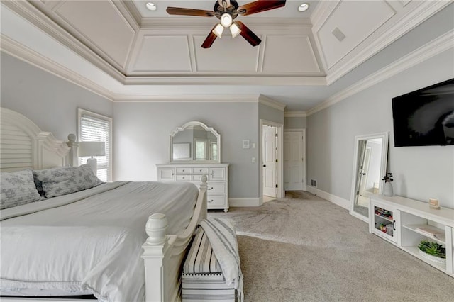 carpeted bedroom featuring a raised ceiling, ceiling fan, and ornamental molding