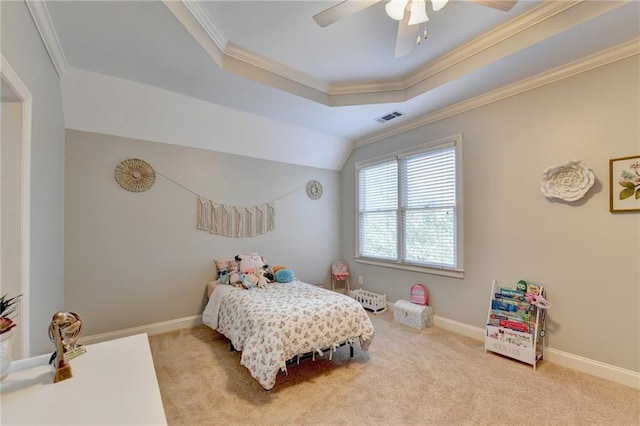 bedroom featuring carpet flooring, ornamental molding, ceiling fan, and a tray ceiling