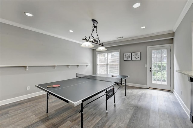 game room with hardwood / wood-style floors, plenty of natural light, and crown molding