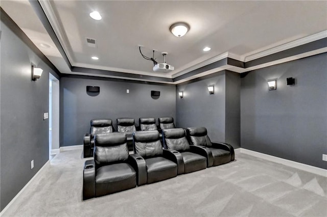 home theater featuring a raised ceiling, crown molding, and carpet flooring