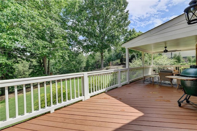 wooden terrace with ceiling fan and a yard