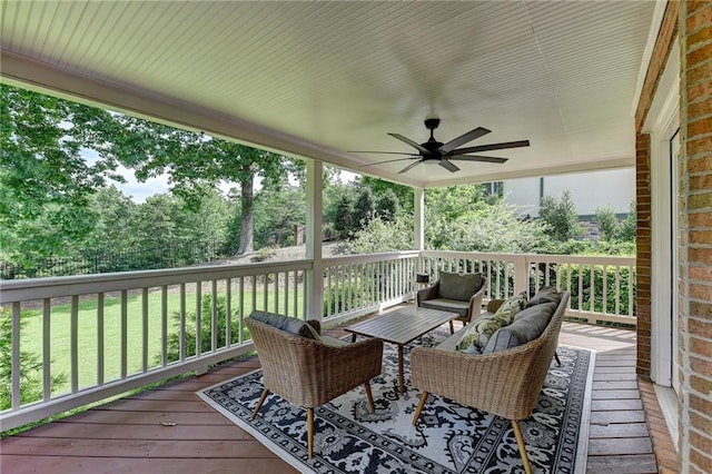 wooden deck featuring ceiling fan