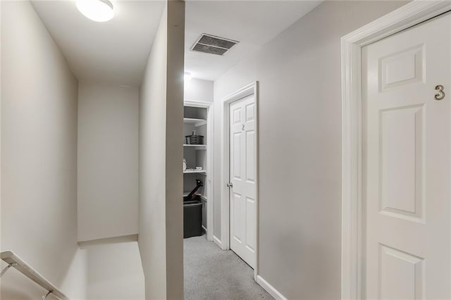 corridor with light colored carpet