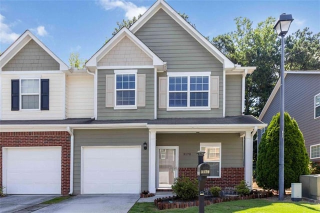 3170 Cedar Glade Ln, Buford, GA 30519 - view of front of house featuring an attached garage, brick siding, driveway, and a porch