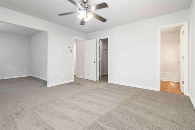 3170 Cedar Glade Ln, Buford, GA 30519 - unfurnished bedroom with carpet floors, a spacious closet, ensuite bath, a closet, and a ceiling fan