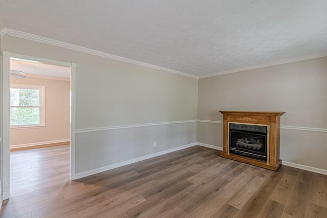 unfurnished living room with hardwood / wood-style flooring and ornamental molding