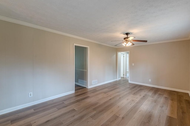 unfurnished room featuring ornamental molding, ceiling fan, a textured ceiling, and light hardwood / wood-style floors