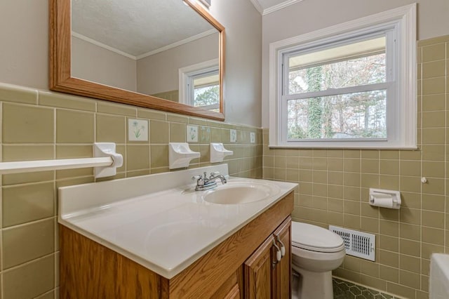 bathroom featuring tile walls, tile patterned flooring, vanity, ornamental molding, and toilet